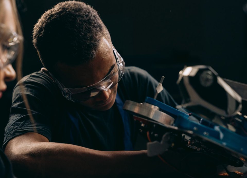 Machine operator wearing safety goggles at work